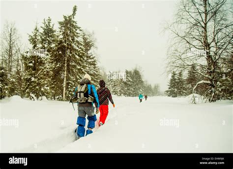 Caucasian Hikers Walking In Deep Snow Stock Photo Alamy