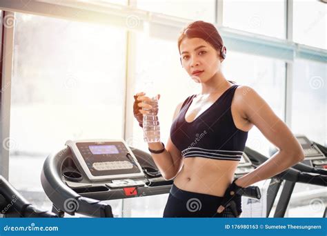 Sporty Woman Asia Drinking Water After Exercises In The Gym Fitness
