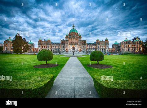 Historic Parliament Building In Victoria With Lights At Twilight With