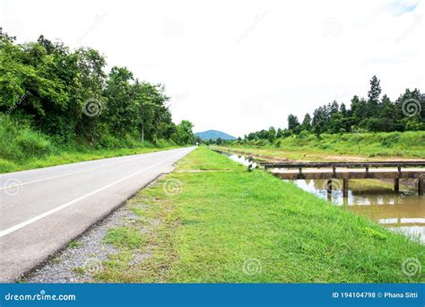 Scenery View Of The Road Beside The River And Concrete Bridge At Rural