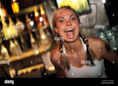 A Young Woman In A Bar Showing Off Her Pierced Tongue In Ground Zero Club Warsaw Poland Stock