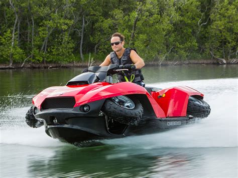 A Man Riding On The Back Of A Red And Black Jet Ski