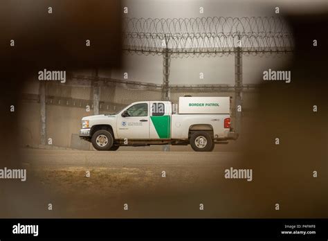 A Us Border Patrol Vehicle Keeps Watch Of The Usa And Mexican Border