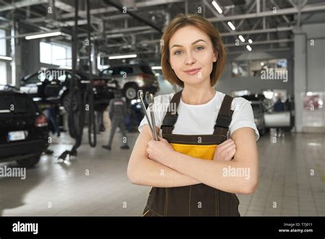 Beautiful Handsome Female Mechanic Looking At Camera Posing Standing