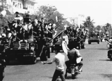 Flag Waving And Jubilating Red Khmer Soldiers Enter The City Of Phnom