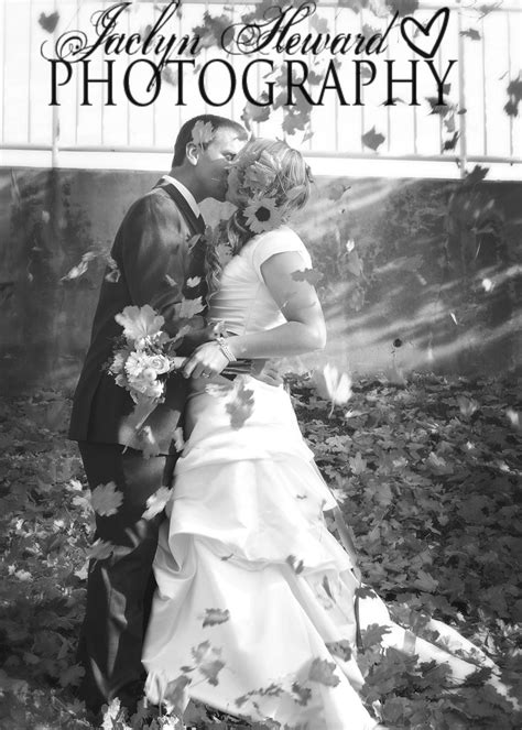 A Bride And Groom Kissing In Front Of A Bridge With The Words Wedding Photography