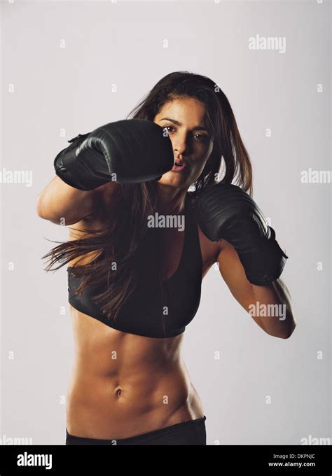 Portrait Of Young Sports Woman Wearing Boxing Gloves Training Boxing