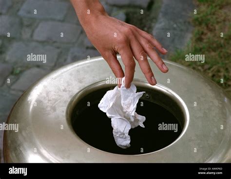 Person Throwing Piece Of Trash Into Garbage Can Stock Photo 5421676