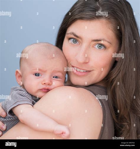 Portrait Of Smiling Mother Holding Baby Boy Months On Her Arm