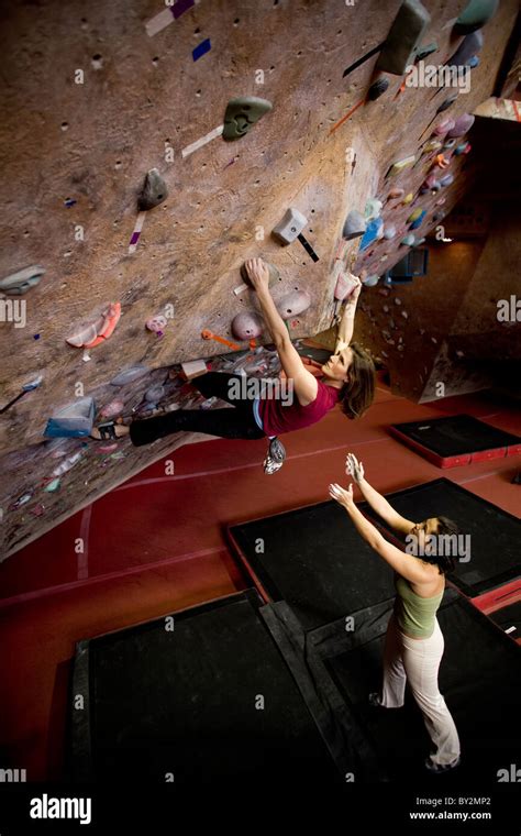 Female Rock Climbers Boulder In A Rock Climbing Gym Stock Photo Alamy