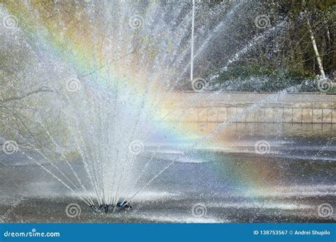 Rainbow In Splashes Of A Fountain As An Abstract Background Stock Image