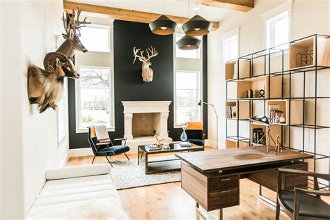 A Living Room Filled With Lots Of Furniture And Deer Head Mounted To