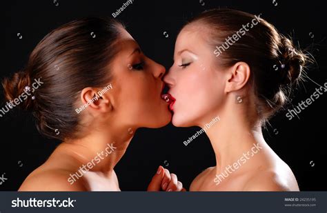 Two Beautiful Women Kissing At Black Background Stock Photo