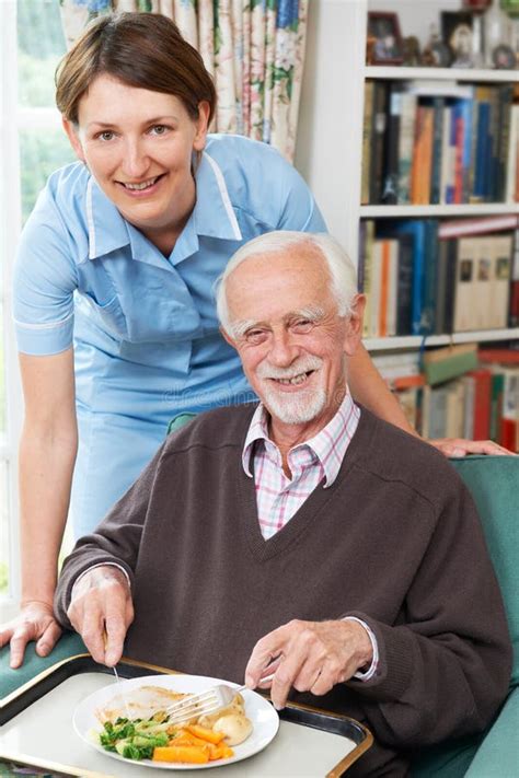 Carer Serving Lunch To Senior Man Stock Image Image Of Care Food