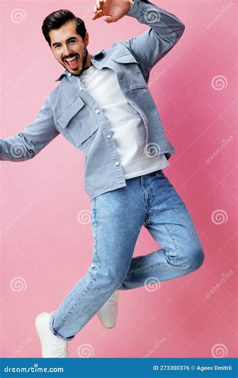Fashion Man With Beard Jumping On Pink Background In White T Shirt And