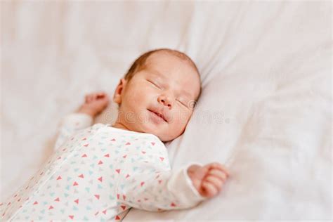Newborn Baby Sleeps Sweetly On White Plaid Newborn Photo Shoot Stock