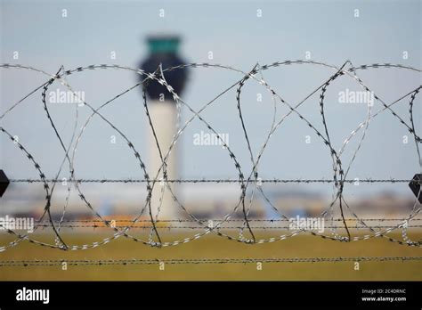 Manchester Airport Air Traffic Control Tower Through Barbed Wire Of The