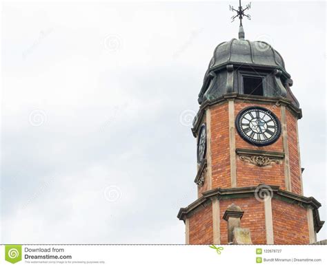 Historic Design Clock Tower In The Top Of A Heritage Building In Cloudy
