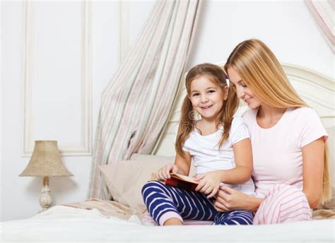 Mother Reading Bed Time Story Book To Her Daughter Stock Image Image