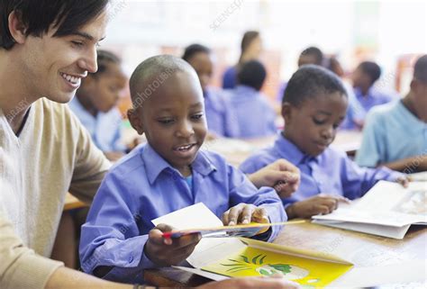 Teacher Working With Student In Classroom Stock Image F0138445