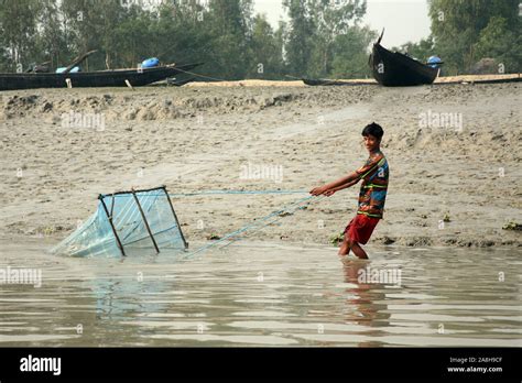 Fisherman Uses Fishing Net In A Traditional Way For Fishing In A Ganges
