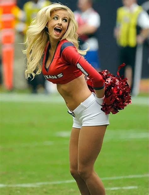 A Cheerleader Is On The Field During A Football Game