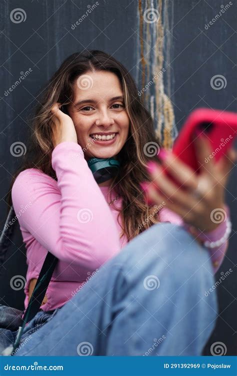 Portrait Of Generation Z Girl Student Sitting Outdoors In The City