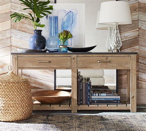 Another option is to include one tall object like a globe, sculpture, or decorative planter for a touch of drama. Parker Reclaimed Wood Console Table | Pottery Barn AU