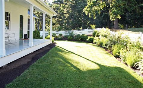 You may not have a lot of money to spend on landscape, but you. A Country Farmhouse: landscaped flower beds with a white picket fence | Farmhouse landscaping ...