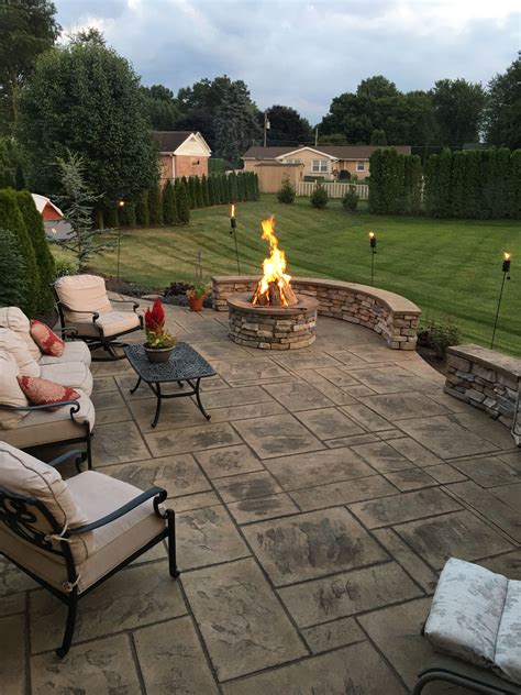 Stamped Concrete Patio With Stone Veneer Wall And Fire Pit Stone Patio