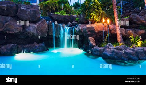 Tropical Resort Pool And Waterfall At Sunset In Hawaii Stock Photo Alamy