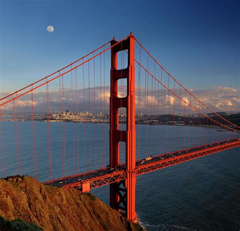 Golden Gate Bridge With San Francisco Skyline And Moon At Sunset