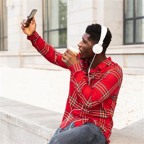 Free Photo Man Taking A Selfie And Listening To Music