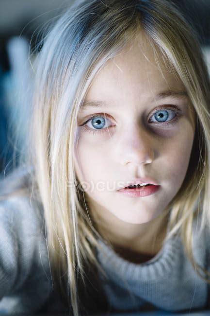 Beautiful Blonde Preteen Girl With Big Blue Eyes Looking At Camera