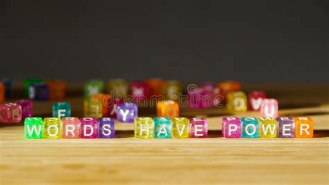 The Phrase Words Have Power On A Wooden Surface Of Colored Square