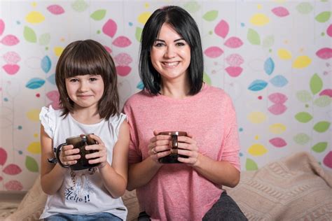 Free Photo Mother And Daughter Drinking Tea From Cups