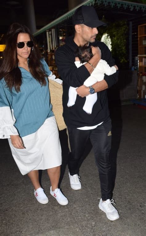 new mommy neha dhupia slays airport look in shirt dress with hubby angad and daughter mehr