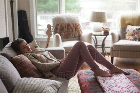 Teenage Girl Relaxing On Sofa Stock Photo Dissolve