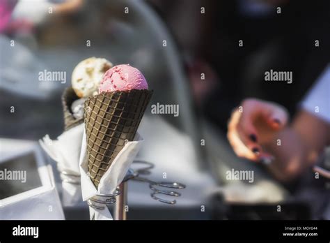 Two Colorful Tasty Ice Cream Cones Woman S Hand Takes Delicious Fresh Ice Cream In Black Cone