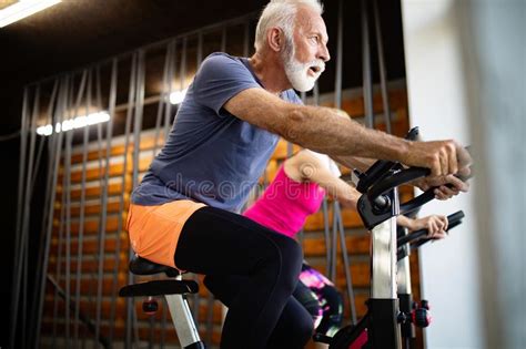 Fit Senior Sporty Couple Working Out Together At Gym Stock Image