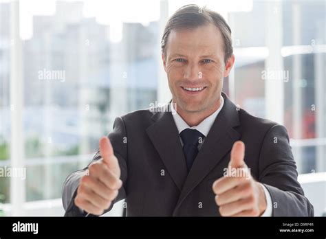 Smiling Businessman Giving Thumbs Up Stock Photo Alamy