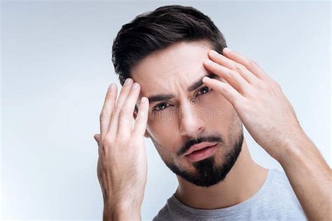 Worried Ill Man Having Strange Feelings In His Forehead Stock Photo