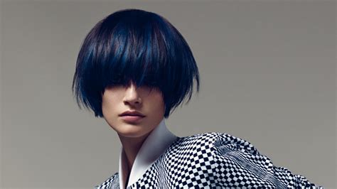 The hair is cut in asymmetric way keeping the front hair with sharper streaks as compared to the hair of back. Short round cut for black hair with blue streaks