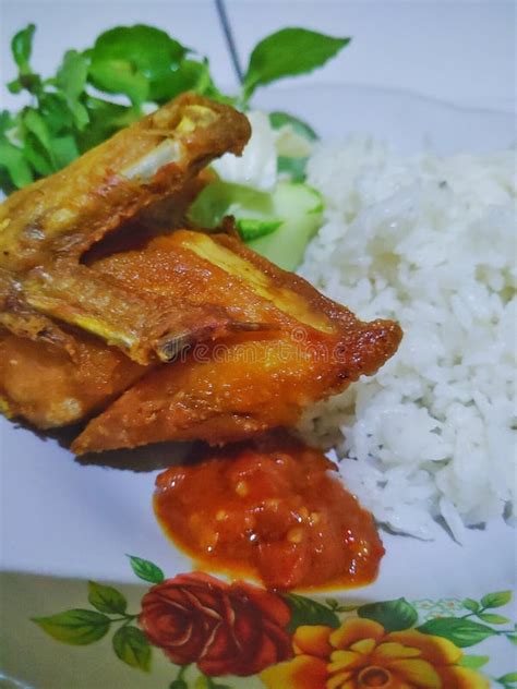 Pecel Ayam Or Fried Chicken Served With Rice Tomato Sauce And Mix