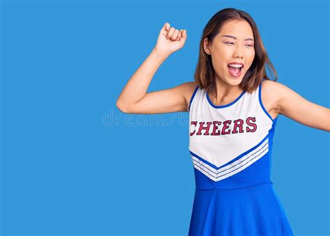 Young Beautiful Chinese Girl Wearing Cheerleader Uniform Dancing Happy