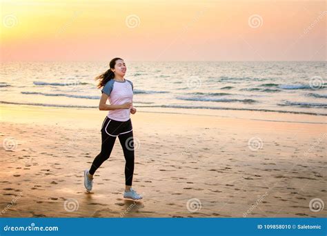 Girl Running On The Beach At Sunset Stock Photo Image Of Jogger