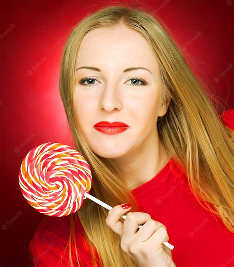 premium photo woman holding lollypop