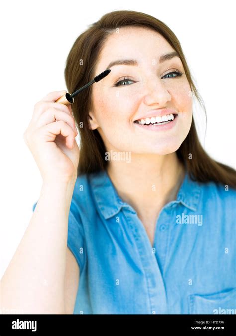 Woman Applying Mascara Stock Photo Alamy