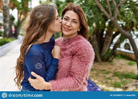 Mother And Daughter Hugging Each Other And Kissing At Park Stock Image