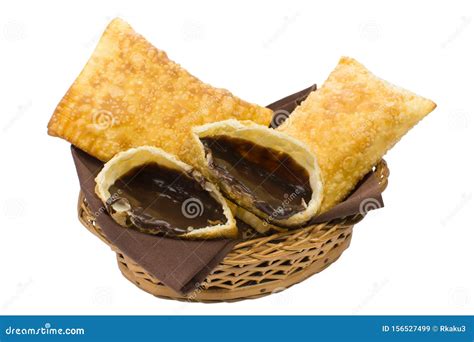 One Open Tradional Brazilian Fried Pastry Called Pastel Stuffed With
